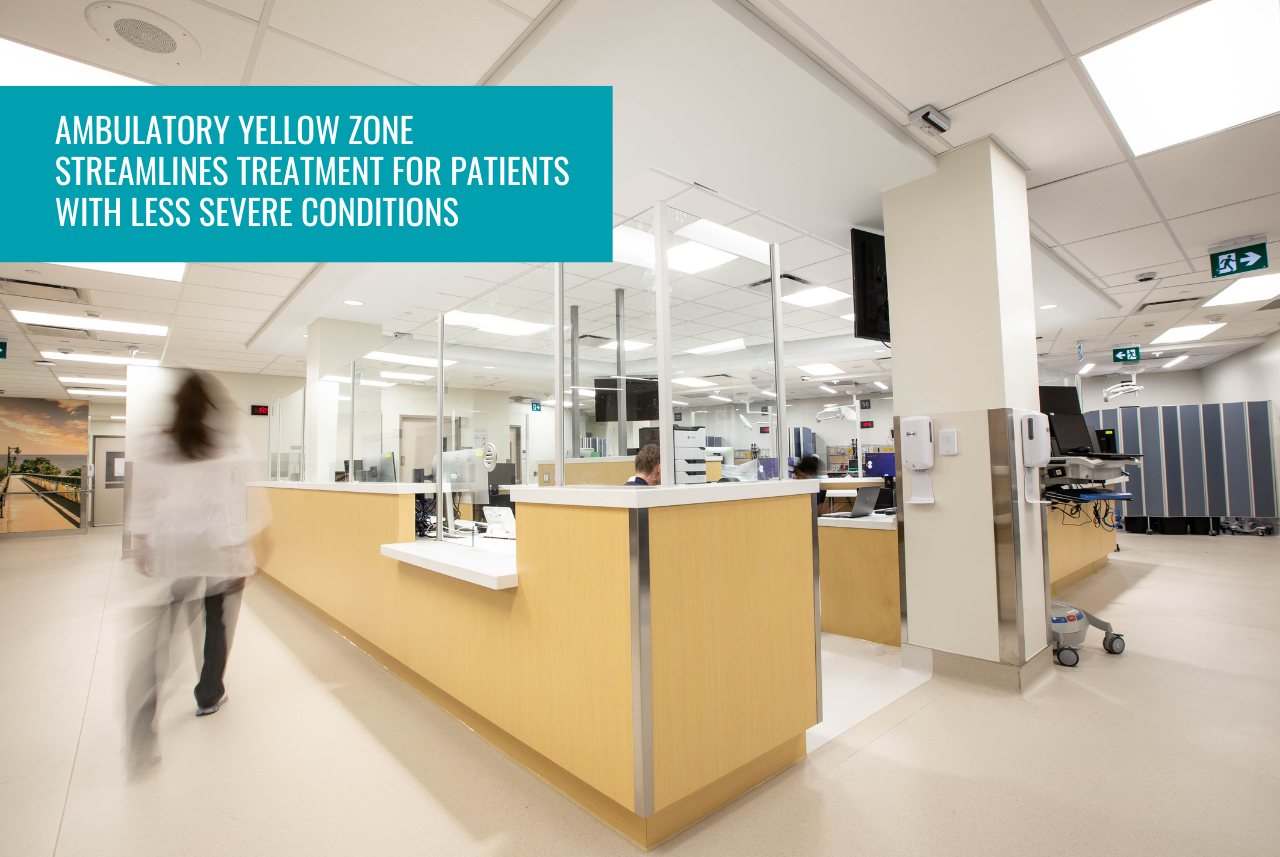 a nurse walks past a large desk in the centre of the emergency department