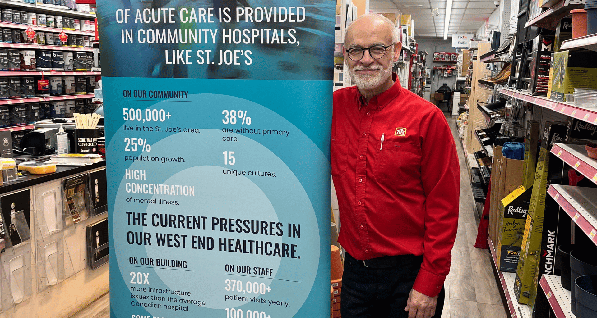 Len from Home Hardware standing in the store by a St. Joe's sign